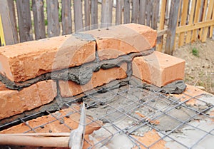 Building brick house wall. Bricklaying and masonry works. photo
