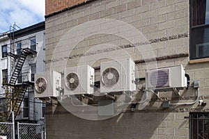 Building brick side wall with serval Air conditioning unites and piping photo