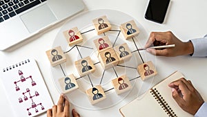 Building a business team with wooden blocks connecting network structure hierarchy