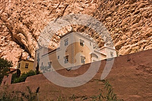 Building in casbah style below giant cliff at Todra Gorge in Morocco