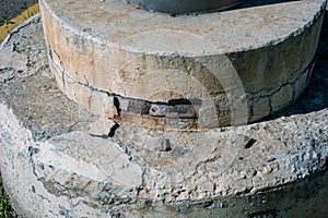 Building: circular plinth in deteriorated reinforced concrete at the base of a pillar. photo