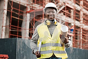 Building the city by hand. a male contractor holding a set of blue prints.