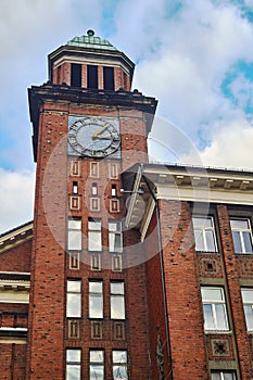 The building with the clock tower of red bric