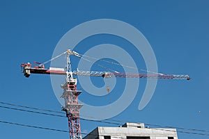 Building. Close-up of a construction crane against the blue sky