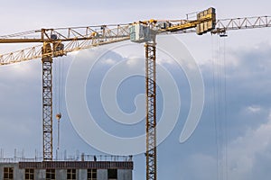 Building constraction site with 2 yellow cranes. Growth concept. Copy space for text photo