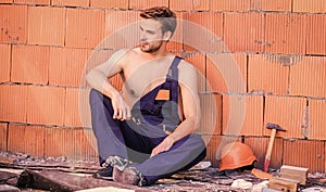 Building construction. Man build own house. Attractive worker. Handsome sexy laborer. Inspecting building. General