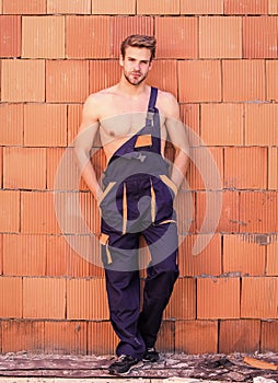 Building construction. Man build own house. Handsome sexy laborer. Attractive worker. Inspecting building. General