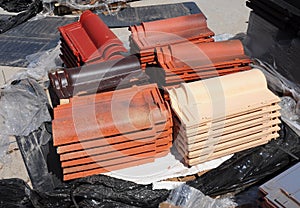 Building and construction materials, colored roof tiles organized on pallets for sale