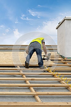 Building construction process of new wooden roof on wood frame house