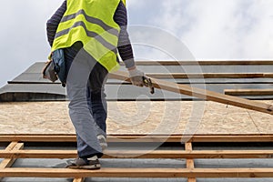 Building construction process of new wooden roof on wood frame house