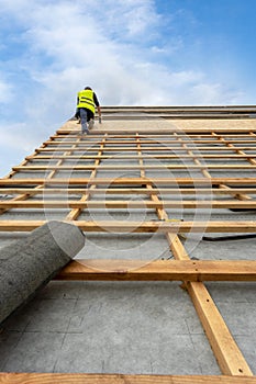 Building construction process of new wooden roof on wood frame house