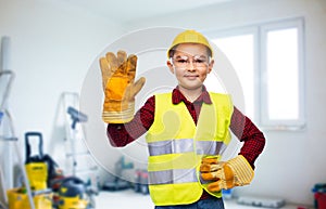 boy in protective helmet, gloves and safety vest