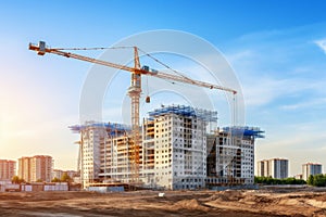 Building construction in progress. construction crane erecting an unfinished tall structure