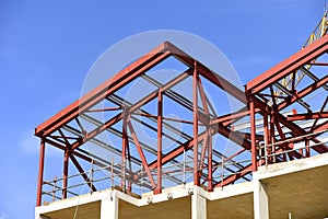 Building construction in progress. Red primer painted steelwork