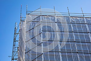 Building construction with scaffolding, blue sky background