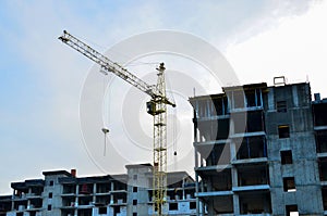 Building construction site with crane against bright blue sky.