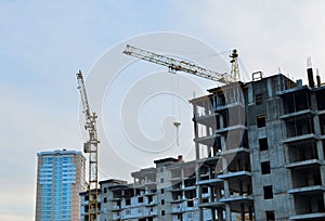 Building construction site with crane against bright blue sky.