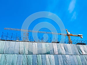 Building construction site with crane tower machinery