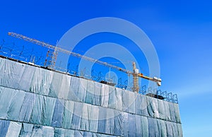 Building construction site with crane tower machinery