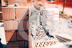 Building construction site. Details of exterior brick walls and cement