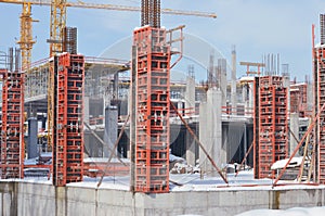 Building construction site with scaffolding under the snow