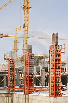 Building construction site with scaffolding under the snow