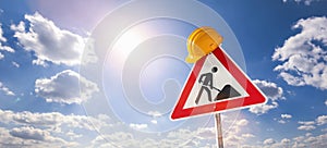 building construction site Street DANGER Sign, with yellow helmet against blue cloudy sky. Under construction concept image