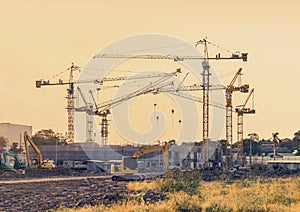 Building construction site with tower crane machinery