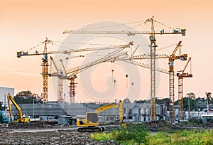 Building construction site with tower crane machinery