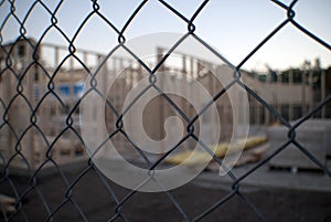 Building construction site through wire fence