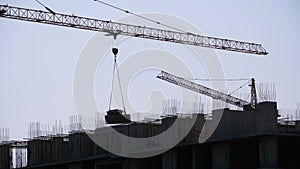 Building Construction. Tower Crane on a Construction Site Lifting Wall Panel