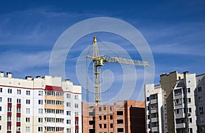 Building crane above tall houses