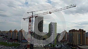 Building crane and building under construction. Construction site. Construction cranes and high rise building under