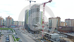 Building crane and building under construction. Construction site. Construction cranes and high rise building under