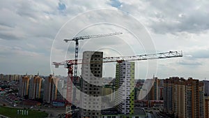 Building crane and building under construction. Construction site. Construction cranes and high rise building under