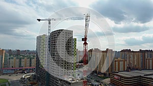 Building crane and building under construction. Construction site. Construction cranes and high rise building under