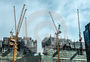 Building crane and buildings under construction and cloudy sky,Bangkok Thailand