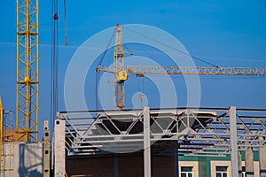 Building crane and construction site over clear blue sky