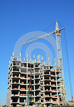 Building cranes on construction site with builders. Building high rise.Crane Construction. Tower Crane and Building Constructors