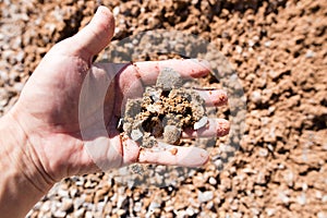 Building crushed stone with sand in hand