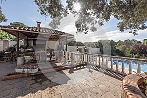 Building dedicated to the warehouse and woodshed surrounded by olive trees and with a pool on one side