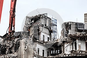 Building demolition by machinery for new construction.
