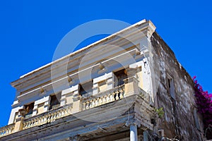 Building in disrepair with typical Caribbean architecture photo