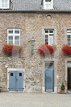 Building doors and red flowers in Aachen