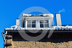 Building with dormer windows and icicles