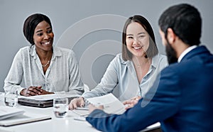 Building on each others ideas like a pyramid puzzle. a businesswoman having a meeting with her colleagues in an office.