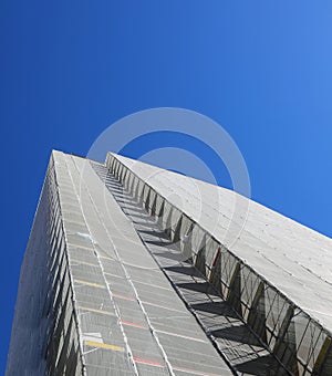 Building entirely encased in scaffolding for maintenance and insulation panel installation