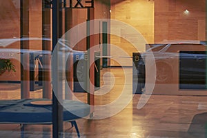 Building entrance, empty entrance inside, evening, blurry reflections in the glass. Lobby entrance with Turnstiles