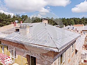 building with external thermo insulation. new roof under construction.