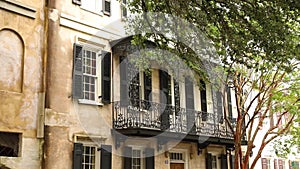 Building facade with balconies decorated with flowers. The beautiful facade.